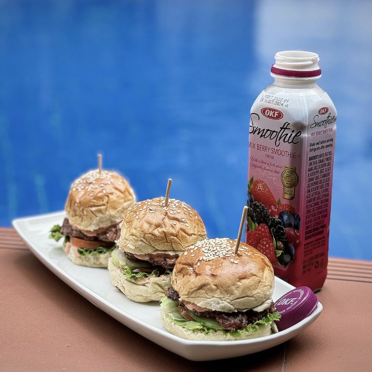 OKF Mix Berry Smoothie served beside three mini burgers